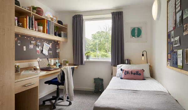 Photograph of a well-lit aesthetically pleasing student bedroom