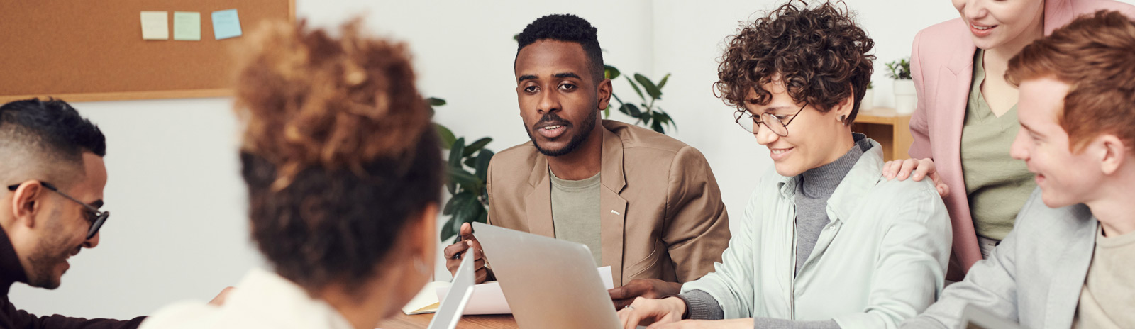 A group of smartly dressed people working around a desk