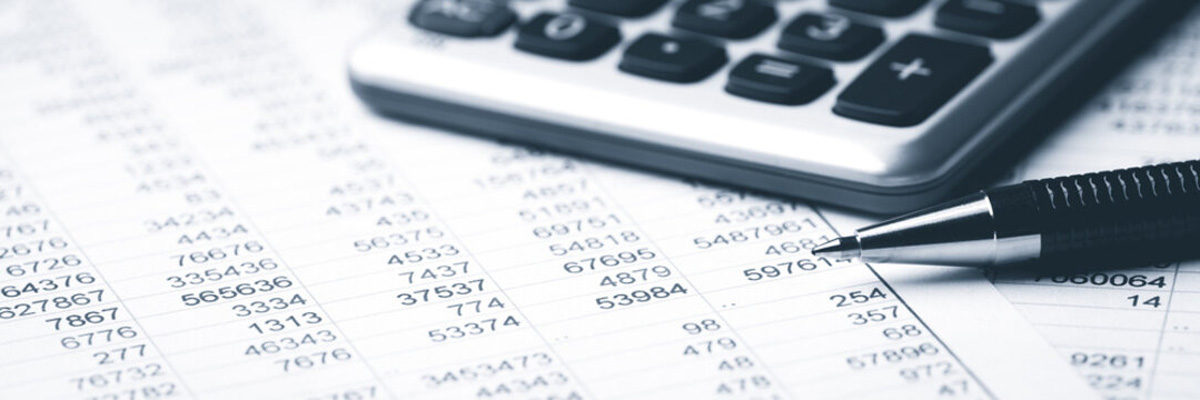 A calculator, pen and some accounts close up
