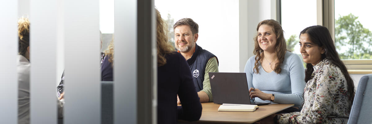 A group of people sitting in a meeting