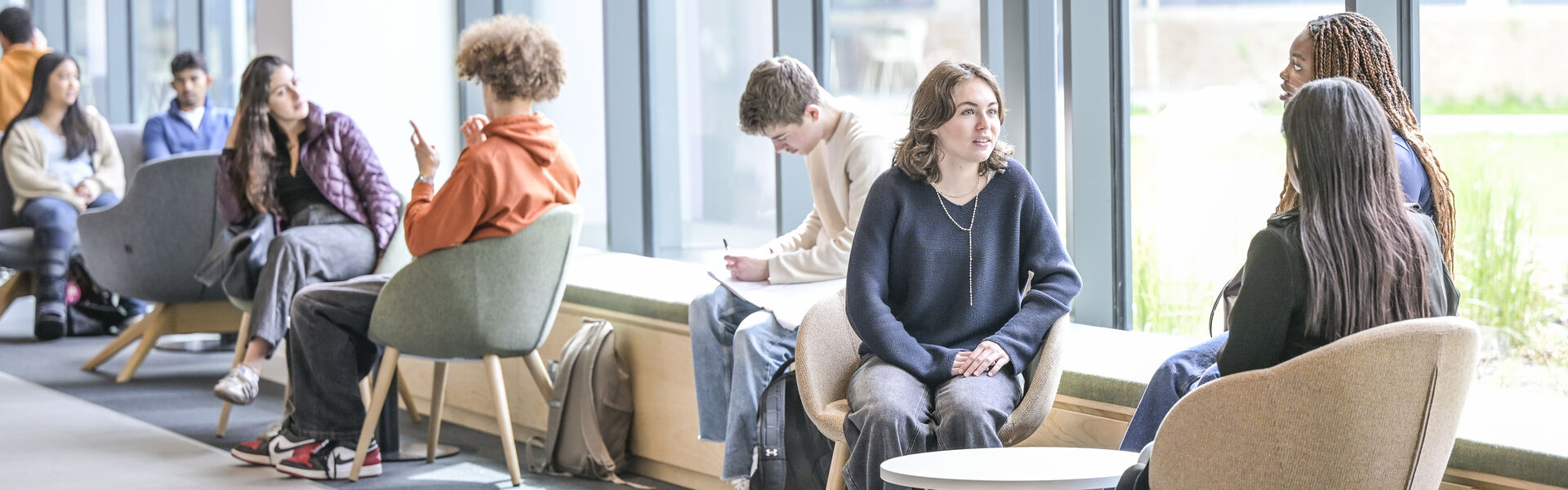 A group of students sitting talking in the Management School