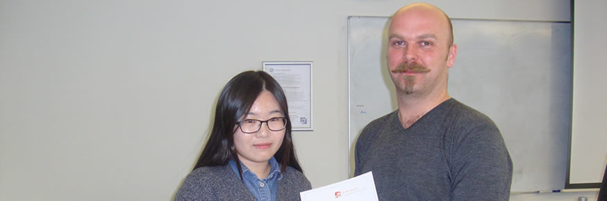 Selfie winner Kun Huang receives her certificate