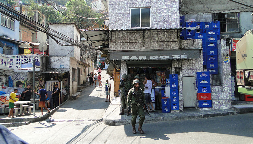 soldiers stand outside a bar in Rocinha