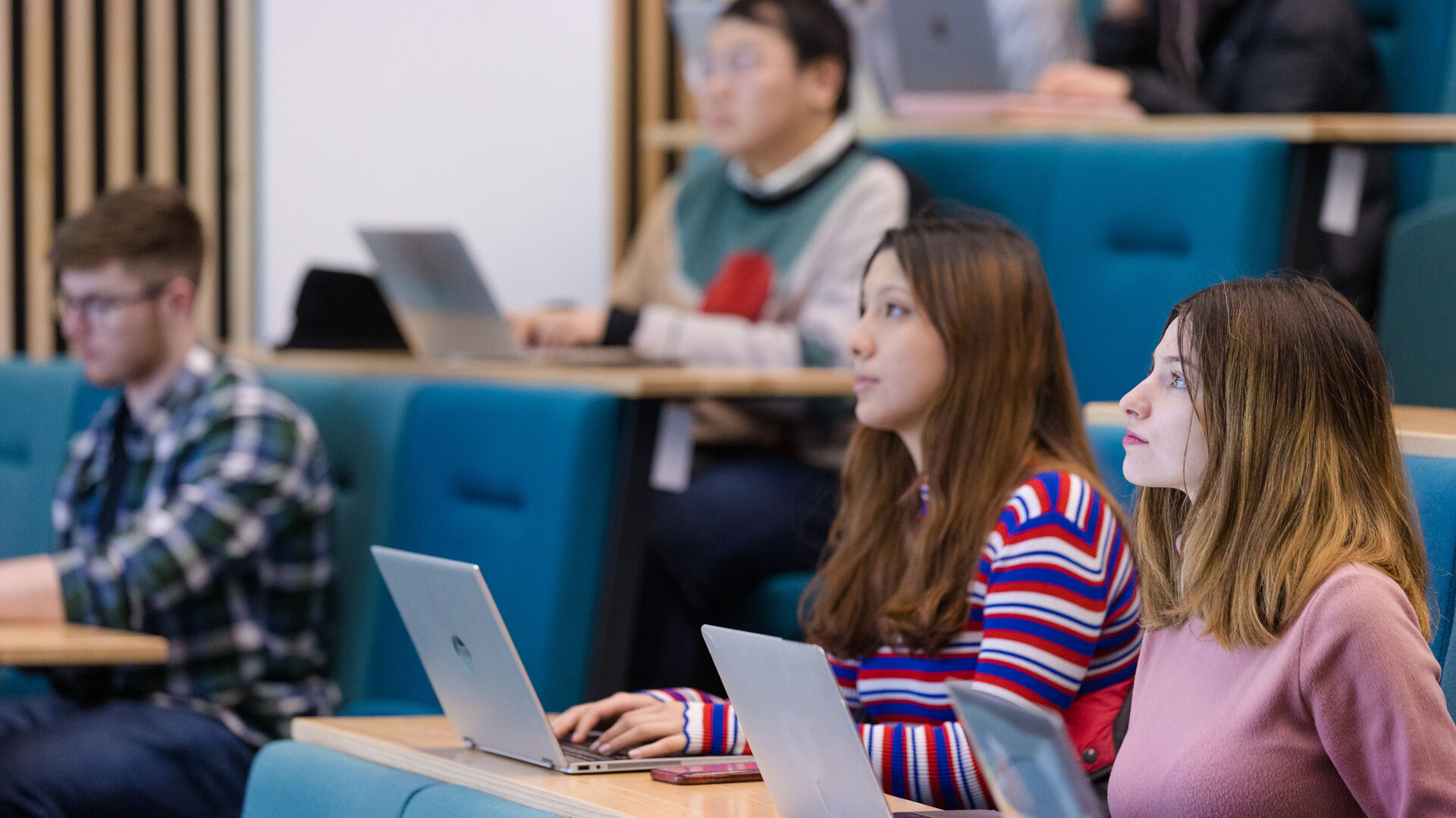 Students in a lecture theatre looking towards the front