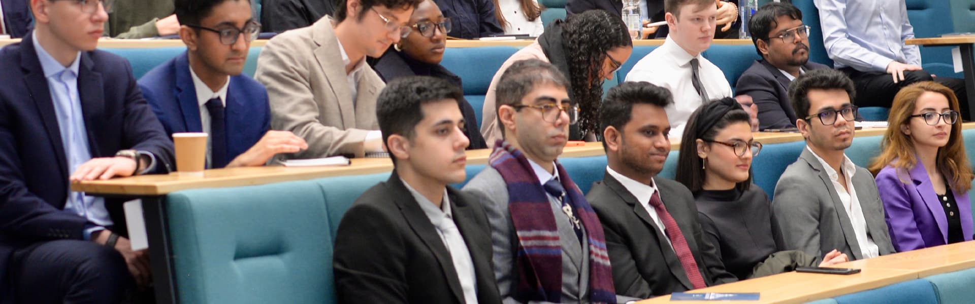 Students sitting in a lecture theatre participating in an Investment and Finance society event 