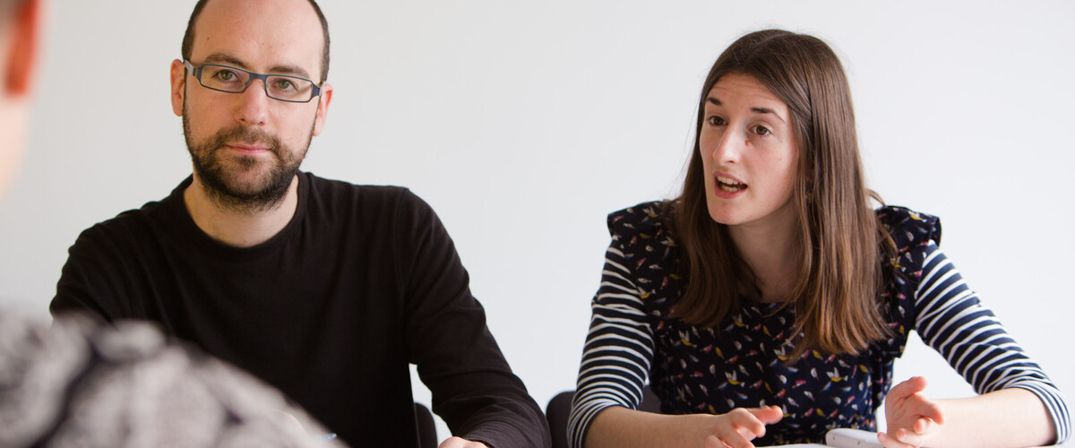 Pair of researchers involved in a group discussion