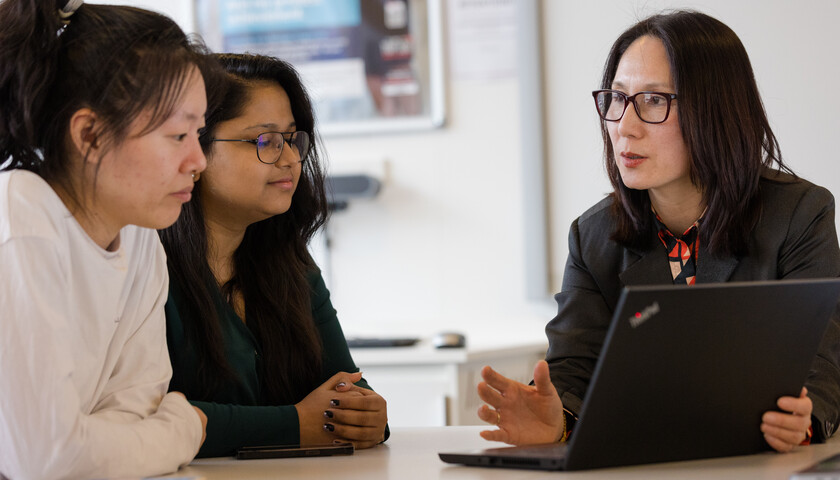 Three people sitting talking