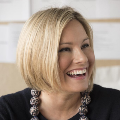 A smiling woman with short blonde hair