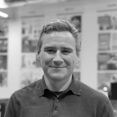 A black and white image of a man with short hair