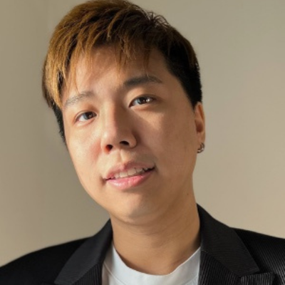 A short haired man looking towards camera