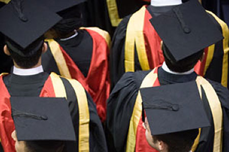 A group of students in graduation robes attending the ceremony.