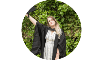 A women on their graduation day wearing traditional graduation gowns and mortar caps