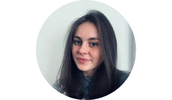 Jess photographed against a plain wall