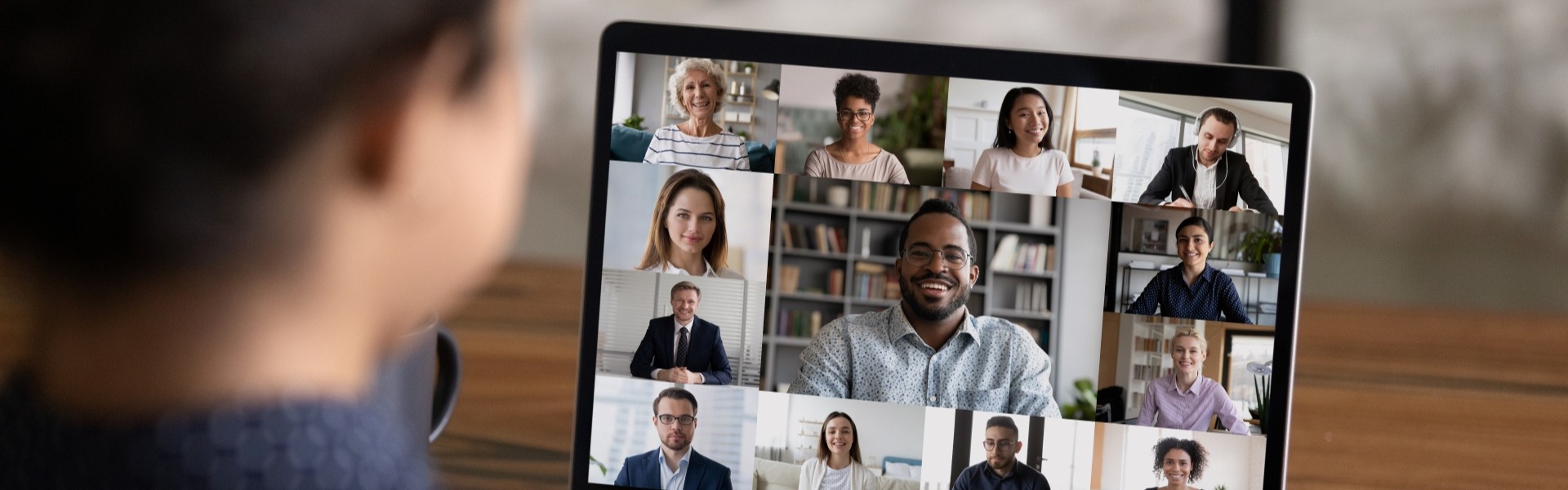 Image of a woman talking to colleagues on a laptop
