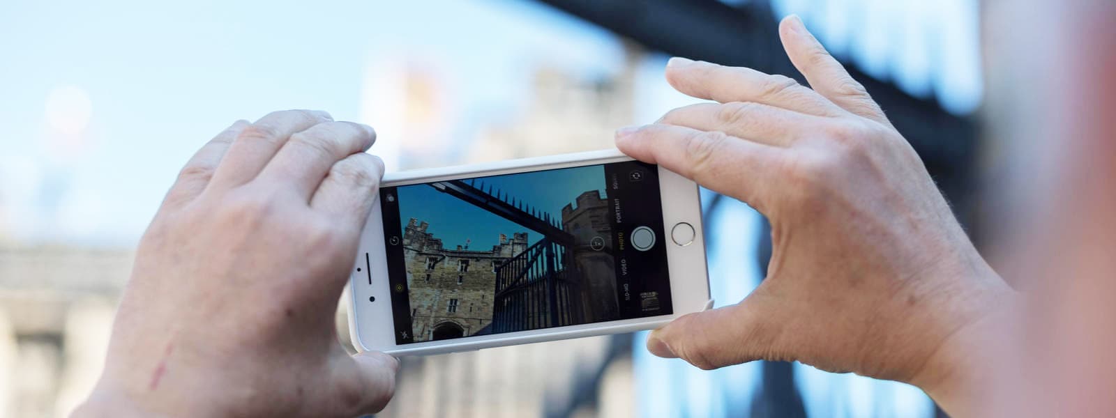 Person using smartphone to photograph Lancaster Castle