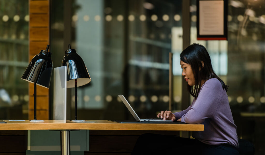 A student sitting at a desk in the library