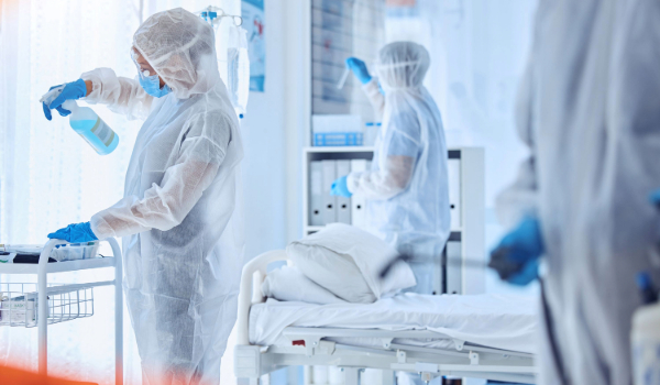 Outbreak control professionals sanitising a hospital ward