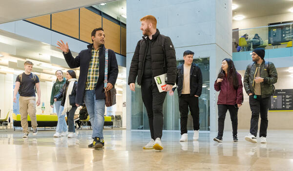 Students walking through the foyer of the Charles Carter building. 