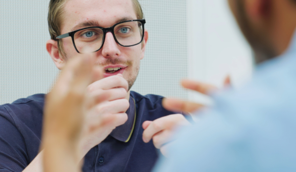 Man talking with hands raised 