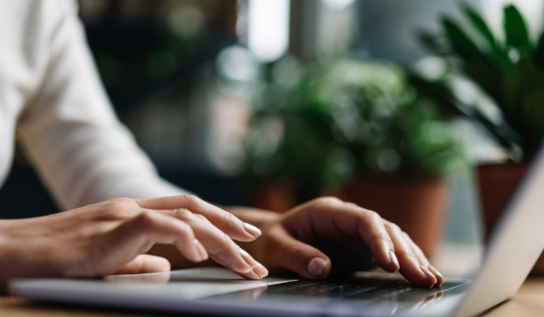 Hands typing on a laptop. 