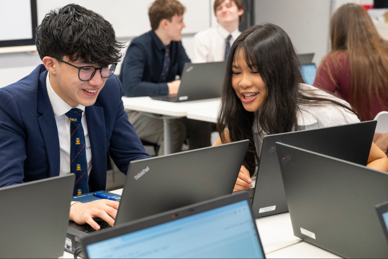 Two Y12 students working on a laptop 