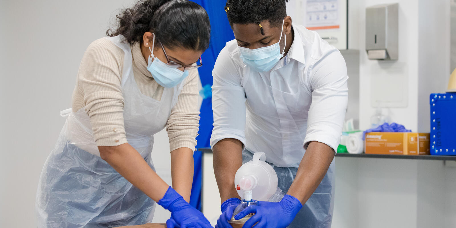 Two students working on model patient in the Clinical Skills Lab