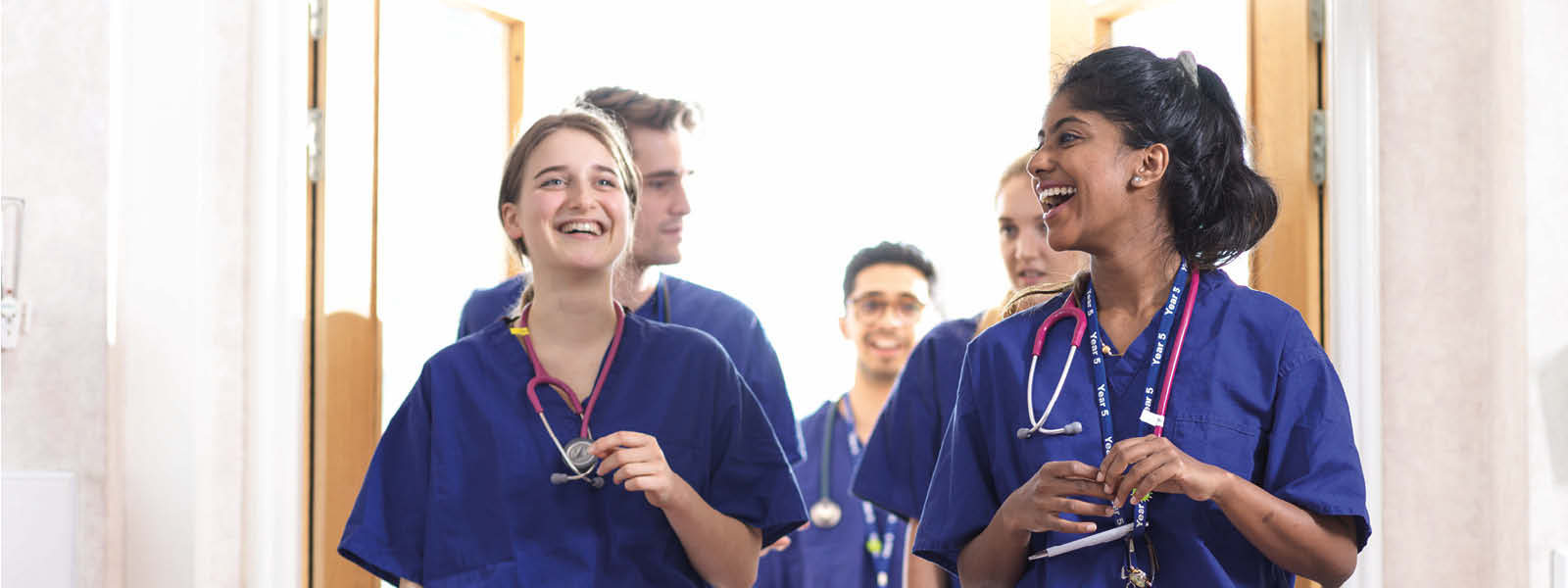 Two medical students walking off a ward