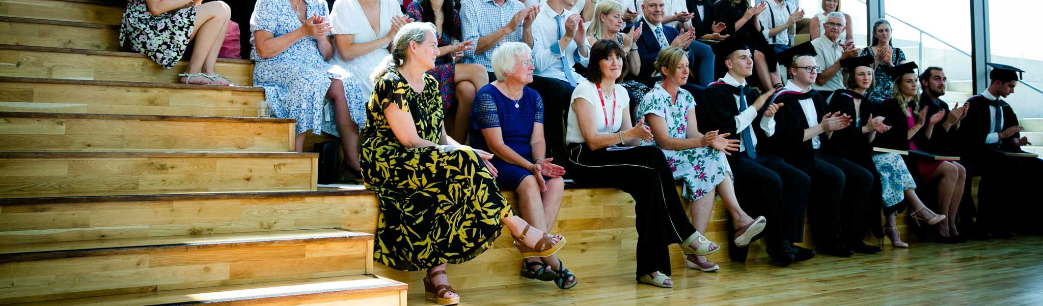 An image of academics and students sitting on steps in the Medical School