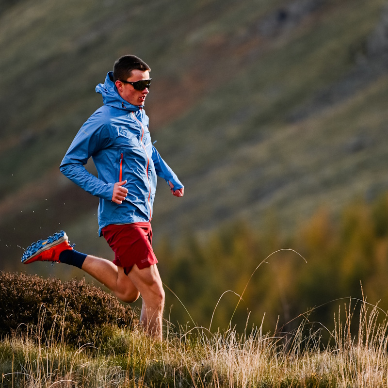Isaac fell running in the mountains, wearing a blue coat and red shorts.