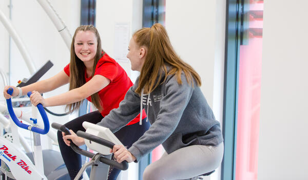 Two students on bikes in the Human Performance Lab