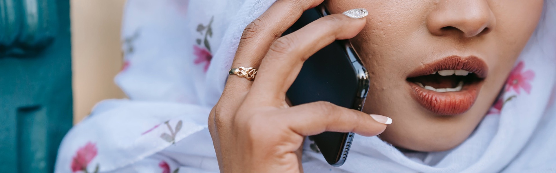 A woman talks into a mobile phone