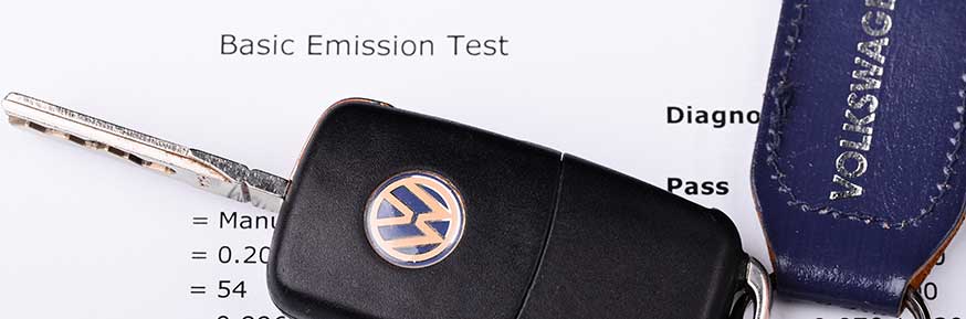 A VW key resting on a emissions test result.