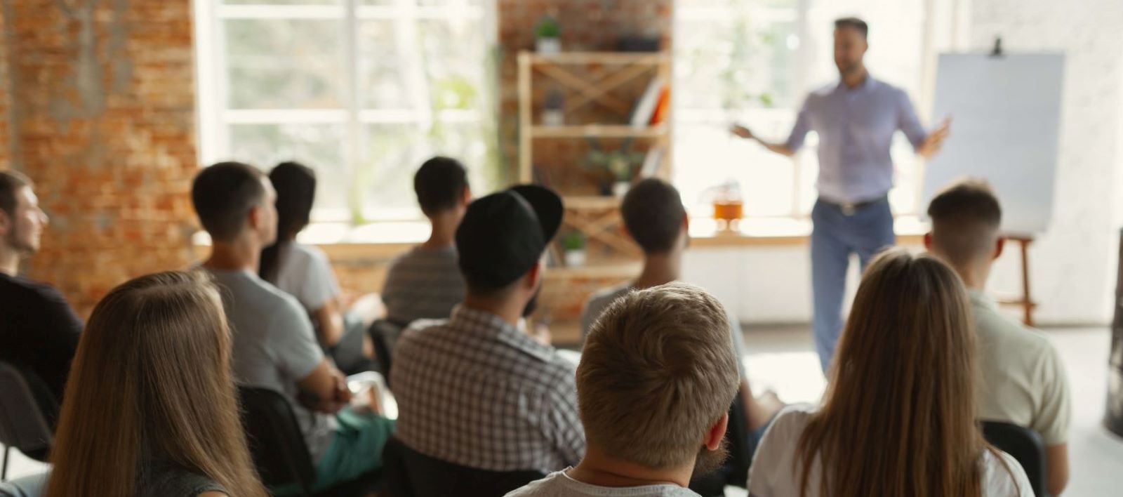 People sat in a training workshop listening to the presenter.