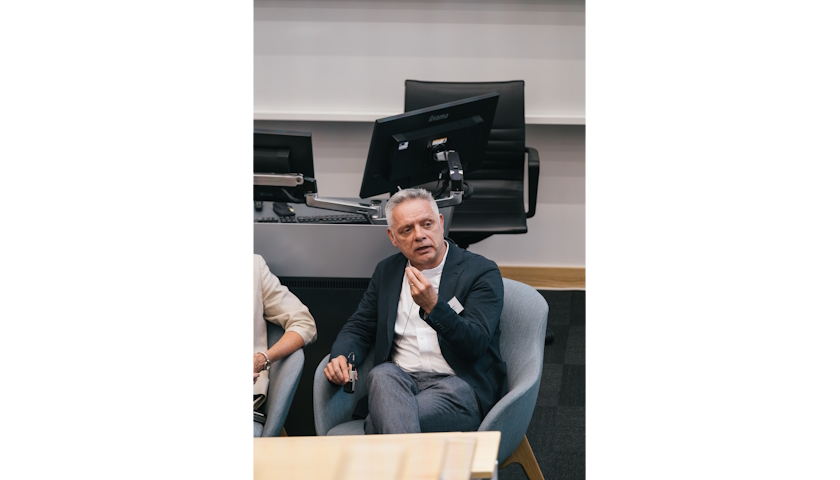 Professor Nick Barter emphasising a point with a hand gesture.
