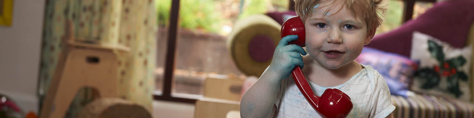 Child talking on a toy phone