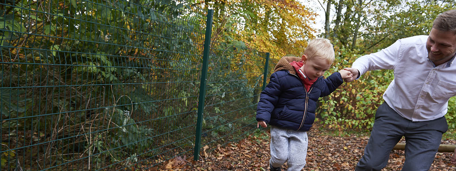 Child and father playing on the outdoor equipment