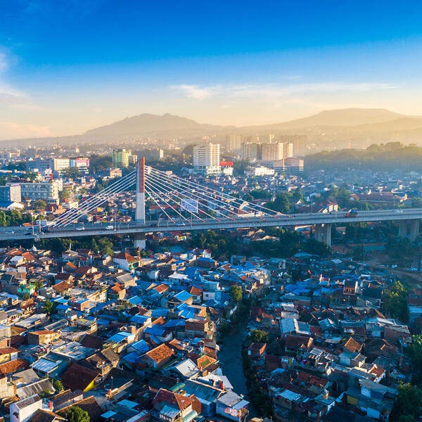A student jogs past a large building of Sunway University campus