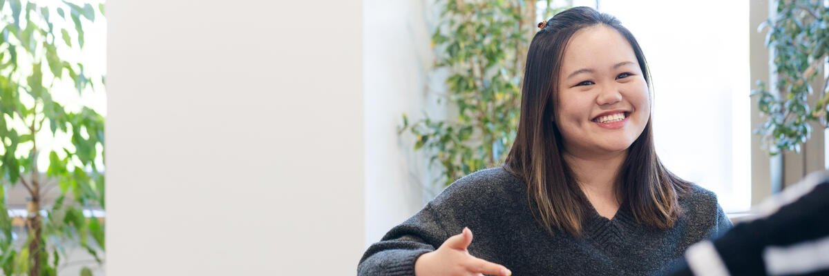 Picture of a women on a sofa having a conversation 