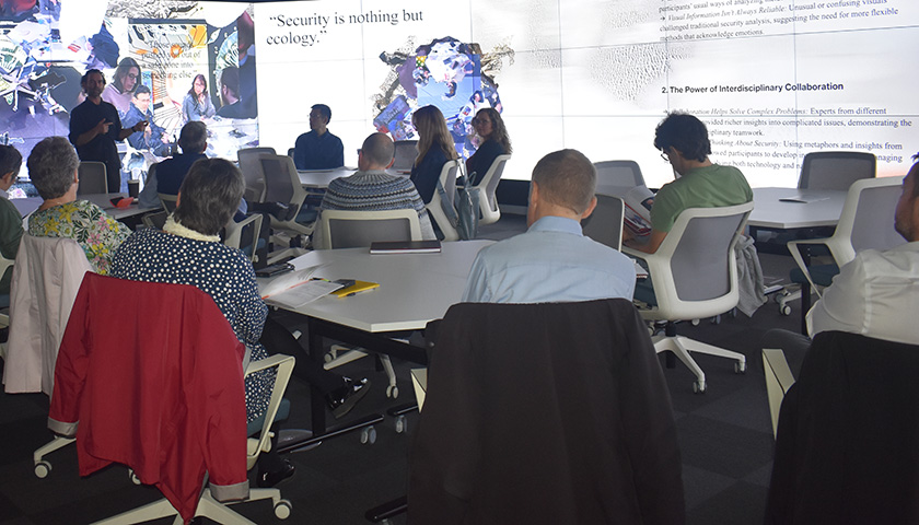 Participants in the Data Immersion Suite, showing the screens used to display the images 
