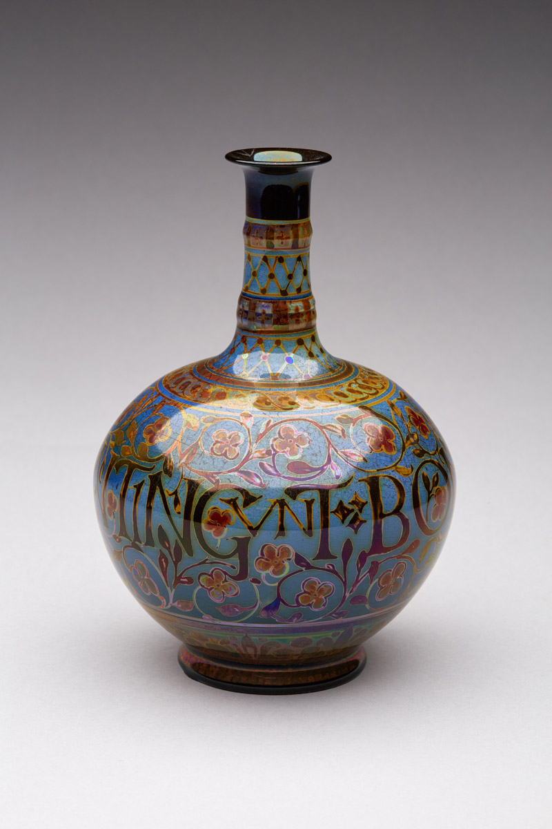 A colourful decorative vase with Latin inscription