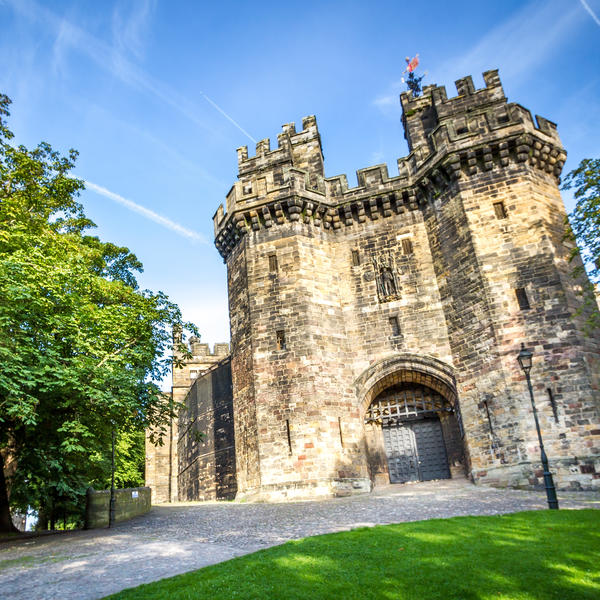 Castle gate with two towers, people in foreground