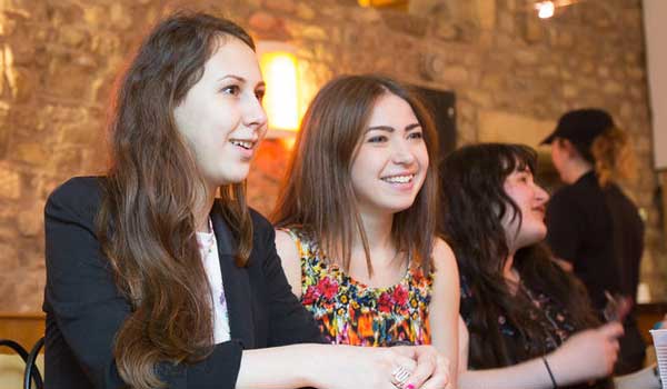 Group of students socialising in a bar