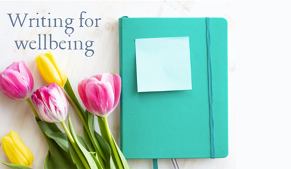 A notebook next to a bunch of tulips