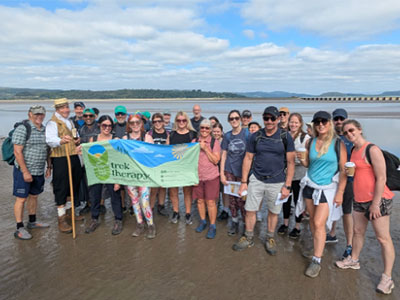Morecambe bay beach large group of people holding a banner