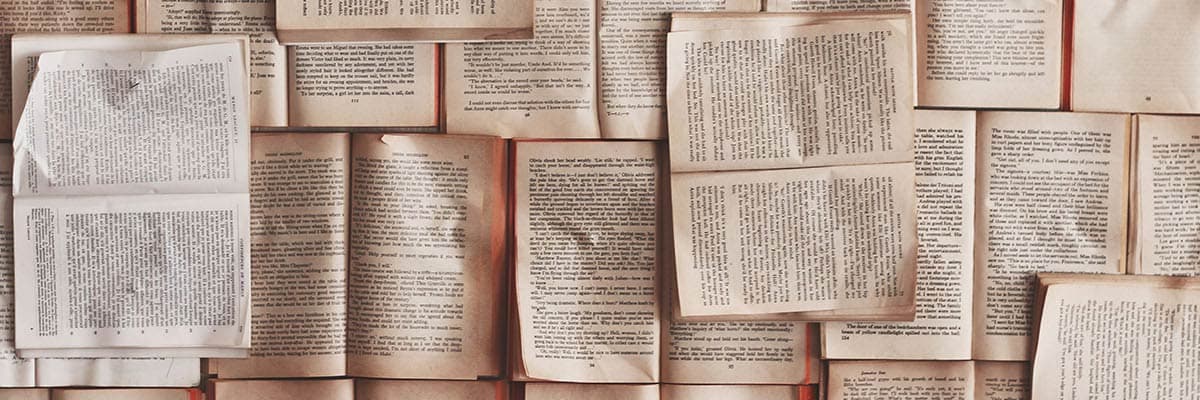 pile of books all open on various different pages of text