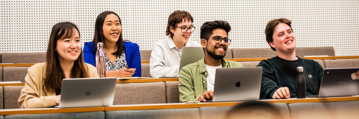 Five students in teaching group with laptops
