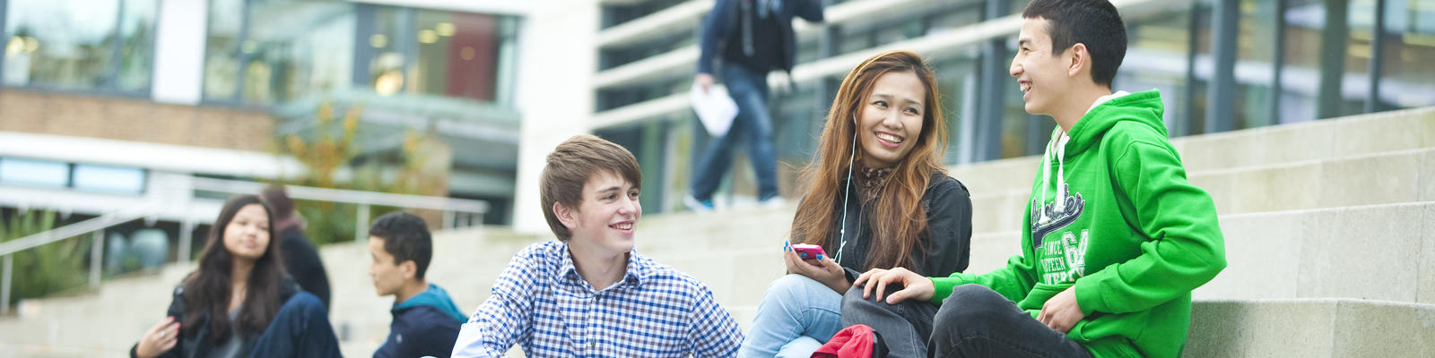 students sitting on steps in Alex Square, Lancaster University Campus