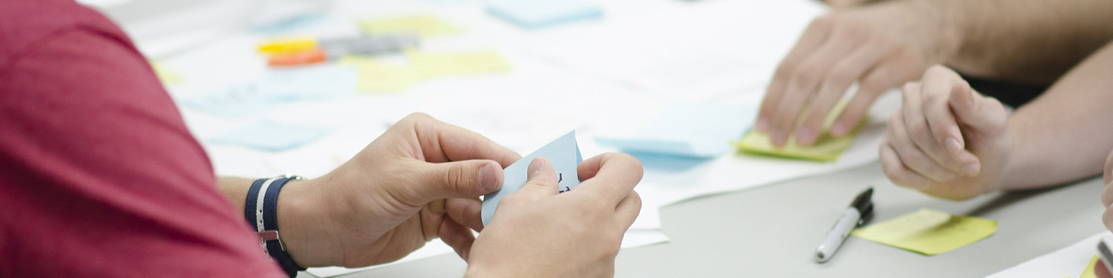 Hands holding sticky notes