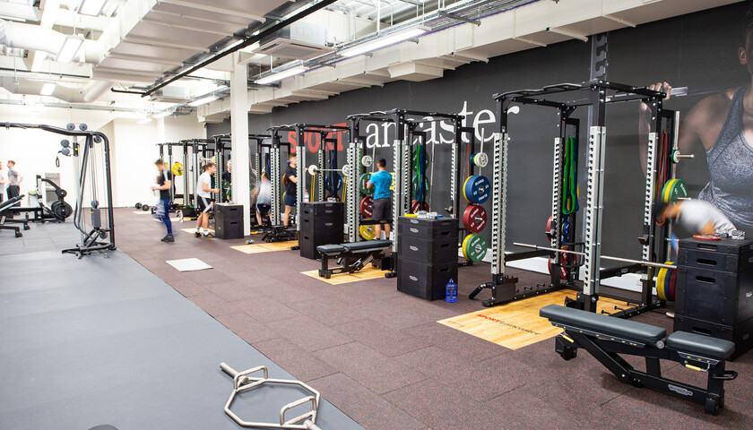 Row of squat racks in the Strength & Conditioning Room 