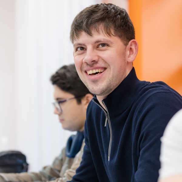 A student smiling widely
